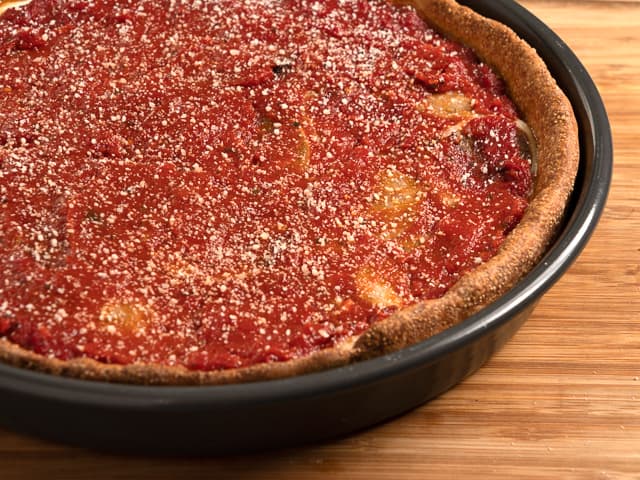 A pan of sausage deep-dish pizza